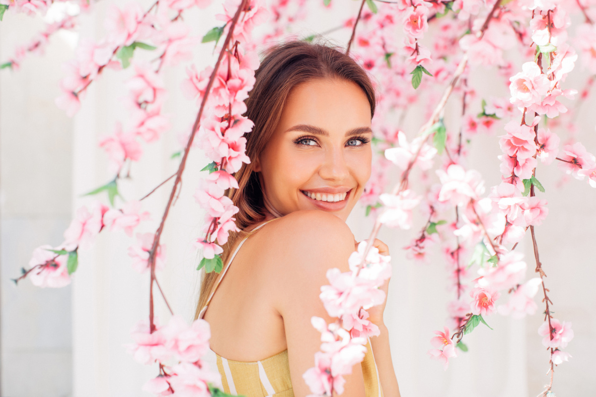 Woman in Spring Flowers Smiling